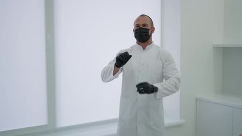 A Doctor in Medical Gloves Presses a Virtual Screen
