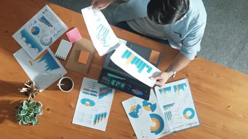 Man Analyzing Financial Data in Modern Office