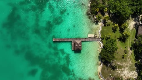 Aerial view above a wooden pier at the Bacalar lagoon, in Mexico - birds eye, drone shot