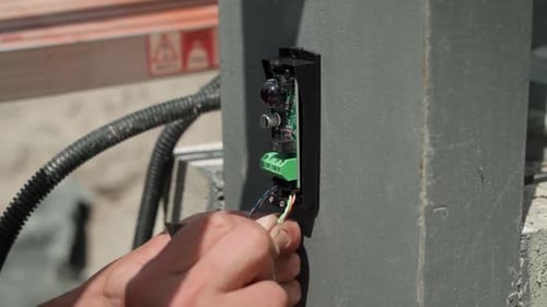Hands Working on Electrical Wiring Close Up