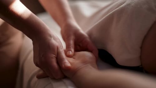 Closeup Cropped Shot of Unrecognizable Female Masseuse Hands Doing Finger and Palm Massage to Male