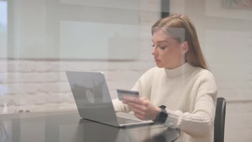 Female Employee Enjoying Online Shopping at Workspace