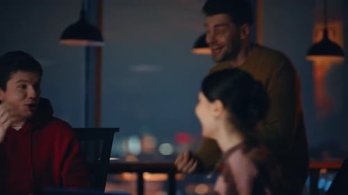 Excited Team Celebrates Technology Success at Night