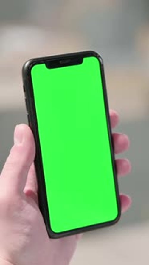 Holding Smartphone with Green Chroma Screen, Vertical Video
