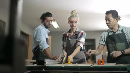Carpenters are working together at workshop.