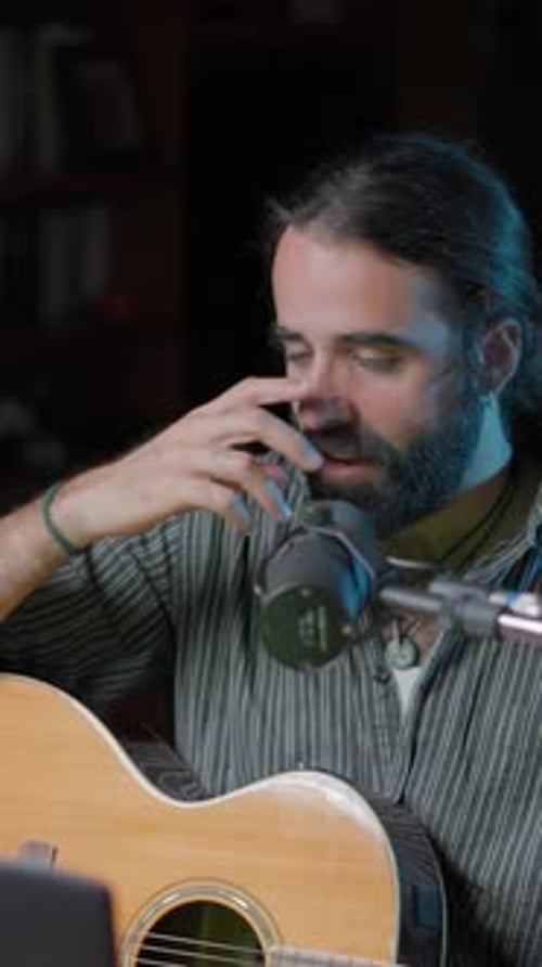 Gimbal Shot of a Music Youtuber Broadcasting Online From His Home Studio