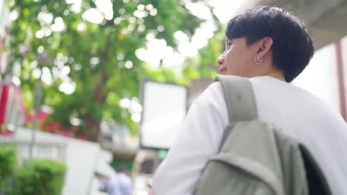 4K Young Asian man walking in the city.