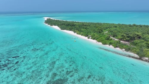 Aerial view of island with turquoise lagoon, Maldives.