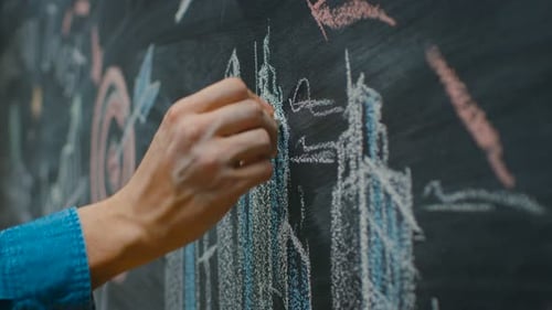 Close-up of Man's Hand Writing and Drawing with Business Success/ Inspirational Words and Pictures