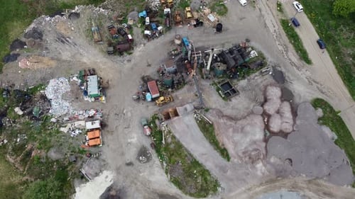 34. Aerial view. Lots of unsorted household waste outdoors.