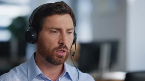 Technical Service Specialist Talking in Headset Solving Issues in Office Closeup