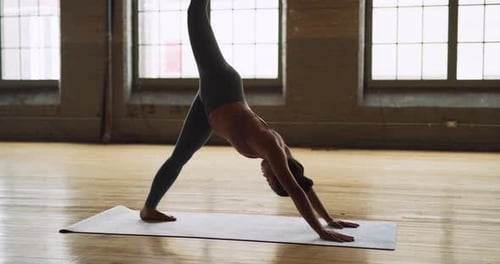 Yoga Practitioner Doing Sun Salutation in Beautiful Brick and Beam Industrial Space