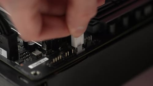 Connector Being Plugged Into a Computer Motherboard