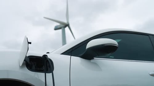 Progressive combination of EV car, charging station and wind turbine.