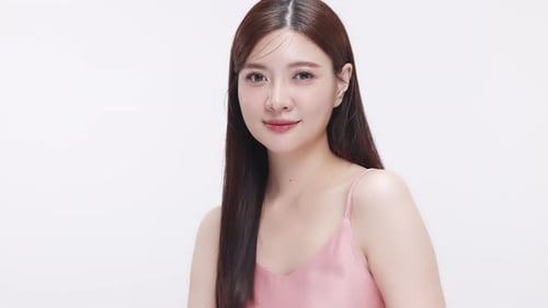 Slow motion shot Close up face of young beautiful young Asian woman with healthy and fresh skin.