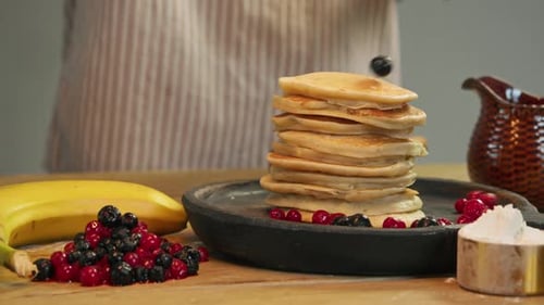 Fresh Red Ripe Juicy Berries are Placed on Top of Pancake Which is Covered in Powdered Sugar on