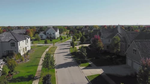 Quiet Suburban Street with Modern Homes Aerial View of a Quiet Suburban Street Lined with Modern