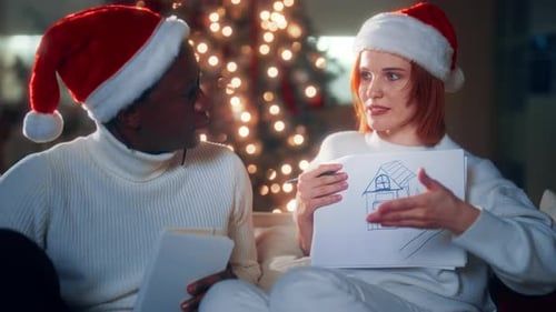 Festive Couple Discussing House Plans at Christmas Time