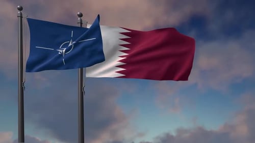 NATO and Qatar Flags Waving Against Cloudy Sky