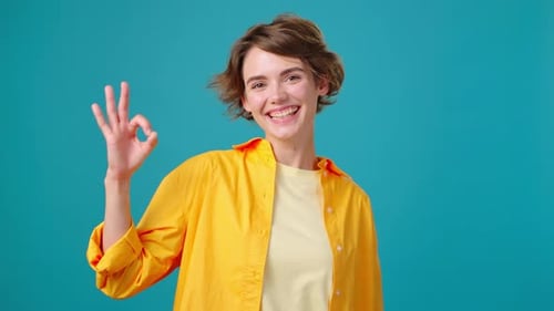 Smiling Woman Makes Okay Gesture