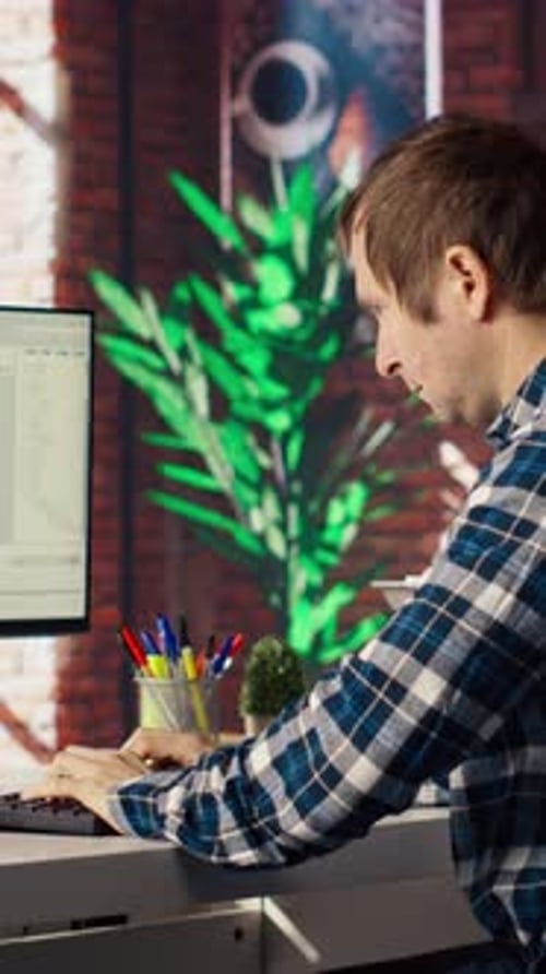 Man at Home Looking at UI on PC Screen Typing and Executing Programming Code