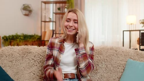 Attractive Woman Talking on Phone While Sitting on Sofa
