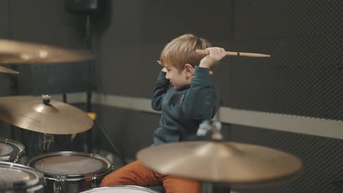 Enthusiastic Boy Plays Drums in Music Studio
