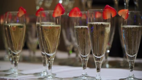 Elegant Champagne Flutes with Strawberries on Table