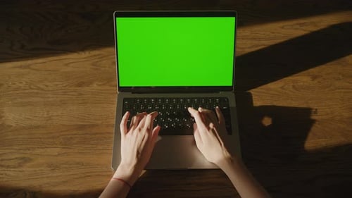 Top View Footage of Caucasian Woman Hands Laying and Typing on a Laptop Computer with Green Screen