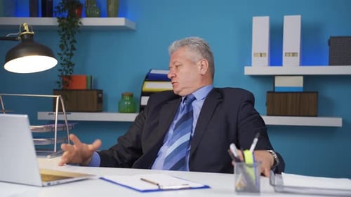 Stressed Man Working at His Desk in Office
