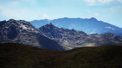 Majestic Mountain Landscape Under Clear Blue Sky in Daytime