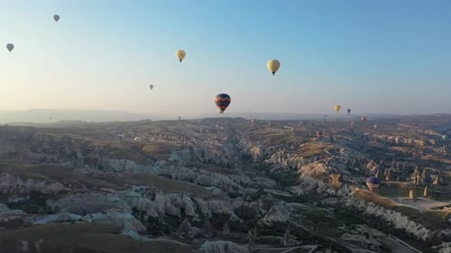 Epic cinematic aerial drone shot flying among the hot air balloons over Cappadocia, Turkey
