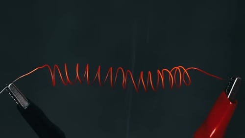 The Nichrome Wire Heats Up to Red with Smoke Under High Electric Current
