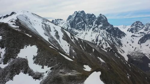 Drone shot revealing the snow covered Georgian Dolomites in the Caucasus mountains in Georgia