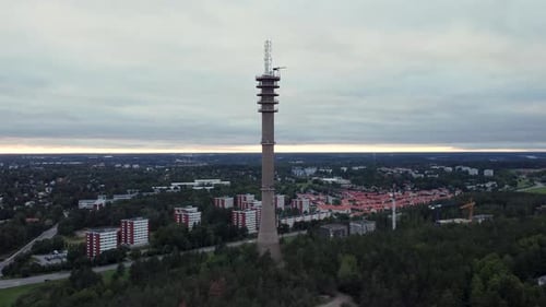 Old cell tower in a suburban area. Dolly in drone shot