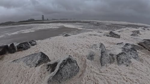 Currumbin Beach With Sea Foam During Cyclone Alfred In Queensland, Australia - Wide Shot