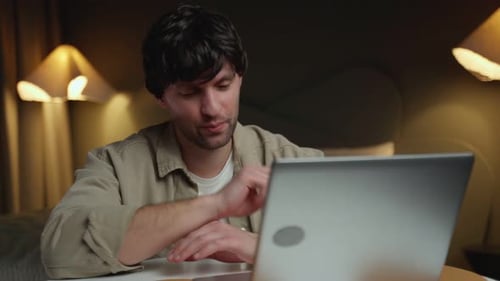 Young Adult Using Laptop on Video Call