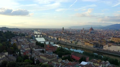 Florence, Tuscany, Italy, October 2021. Drone pushes west along the Arno river with Piazzale Michela