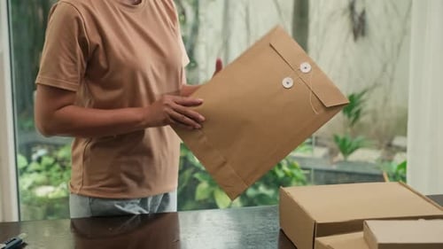 Adult Opening Mail at Table