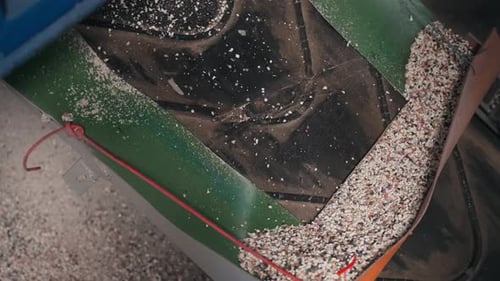 Rubber Granulate Moving Through Conveyor in Recycling Factory