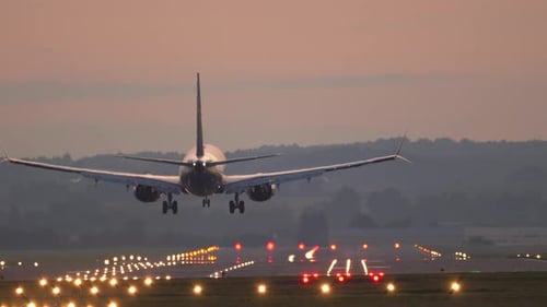 The plane lands at the airport.
