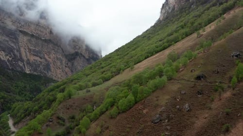 Scenic Mountains with Lush Green Hillside and Misty Cliffs