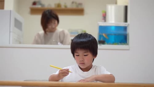 Child Drawing with Mother in Background at Home