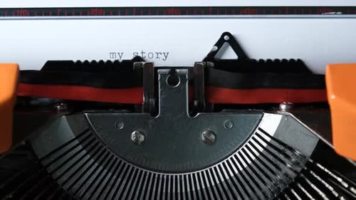 Typing My Story on Orange Vintage Typewriter