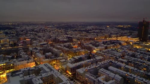 Berlin City lights, rooftops covering in snow winter at dusk. Nice aerial view drone