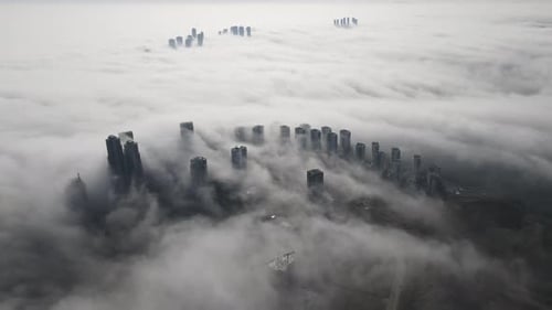 City Skyline Emerging from Fog, Aerial View