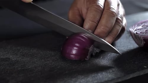 Red Onion Being Cut with a Knife