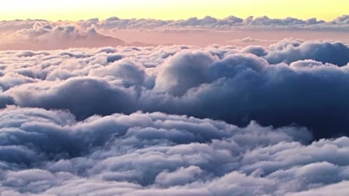 Aerial View of Fluffy Clouds at Sunrise or Sunset