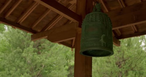 Temple bell moving in the breeze, medium close up.