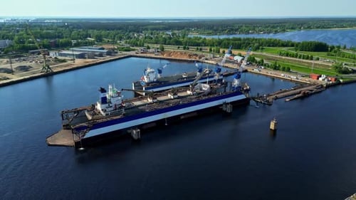 Massive Industrial Cargo Ships Docked at Busy Modern Port Facility